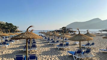 On the beach, sun-loungers, beach umbrellas, beach towels
