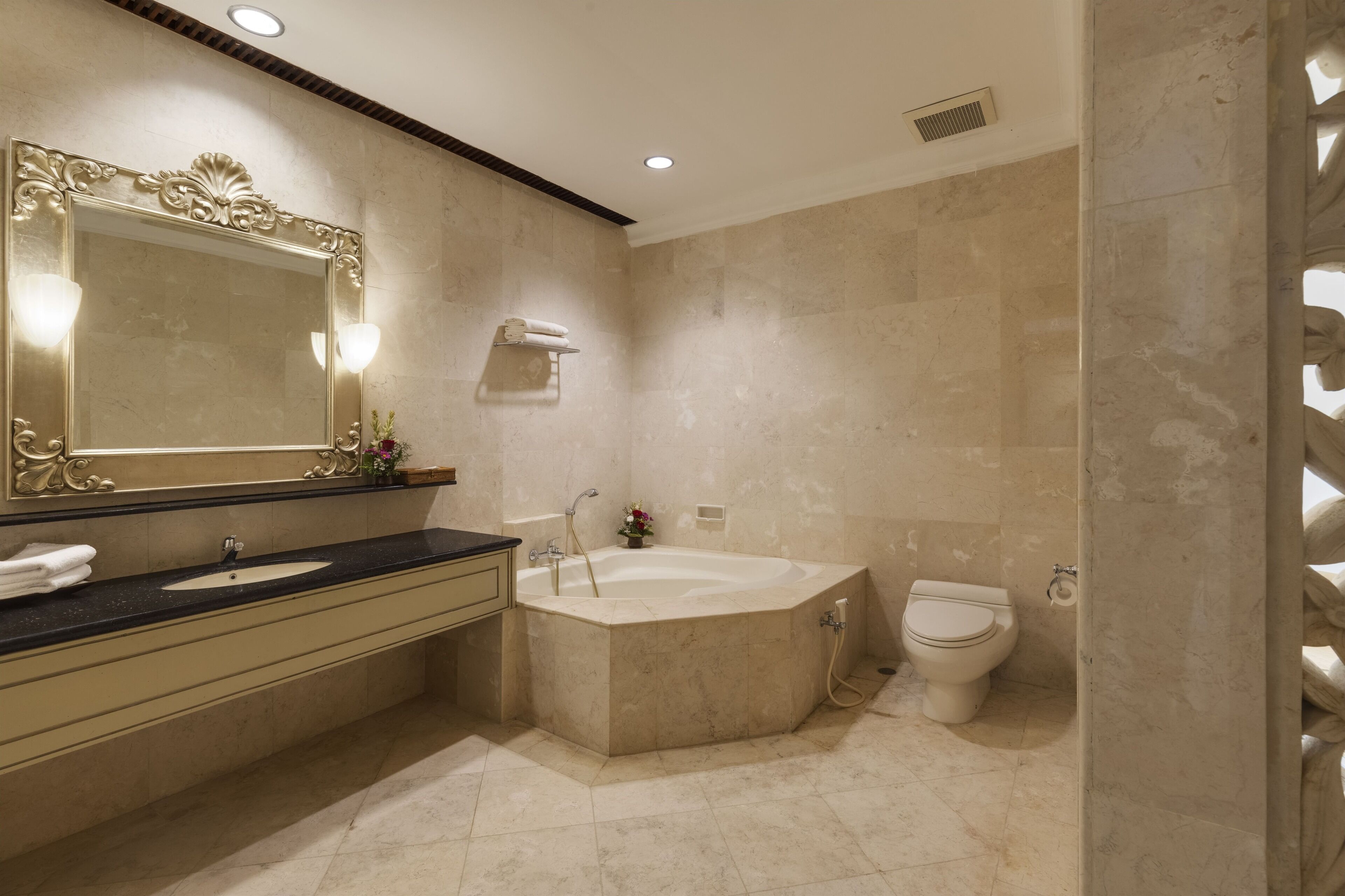 deluxe suite | bathroom | bathtub, free toiletries, hair dryer, slippers