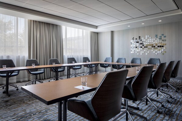 A conference room with a long table, multiple chairs, and a patterned carpet. - Dallas/Plano Marriott at Legacy Town Center (Plano)