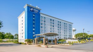 A Holiday Inn Express hotel with a blue and white facade, a covered entrance, and a parking lot. - Holiday Inn Express & Suites Baltimore West - Catonsville by IHG (Catonsville)