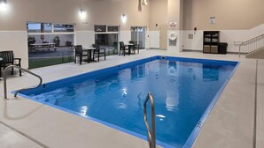 A swimming pool with a lifeguard chair, poolside chairs, and a table with chairs. - Quality Inn & Suites Coeur d'Alene (Coeur d'Alene)