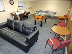 Relax in this stylish space with a sofa, coffee table, and comfortable chair. Enjoy games with the ping pong and foosball tables.