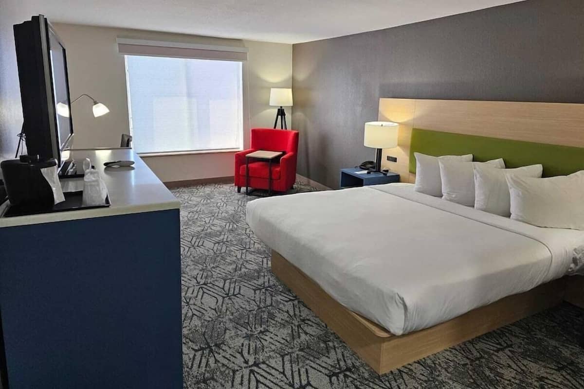 Premium bedding, desk, laptop workspace, blackout drapes