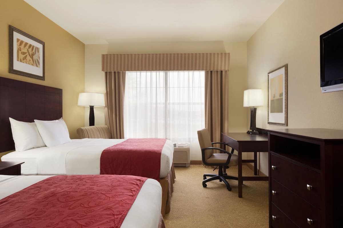 Premium bedding, desk, laptop workspace, blackout drapes
