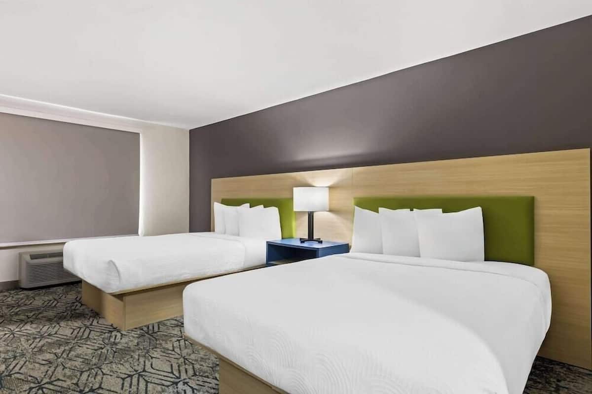 Premium bedding, desk, laptop workspace, blackout drapes