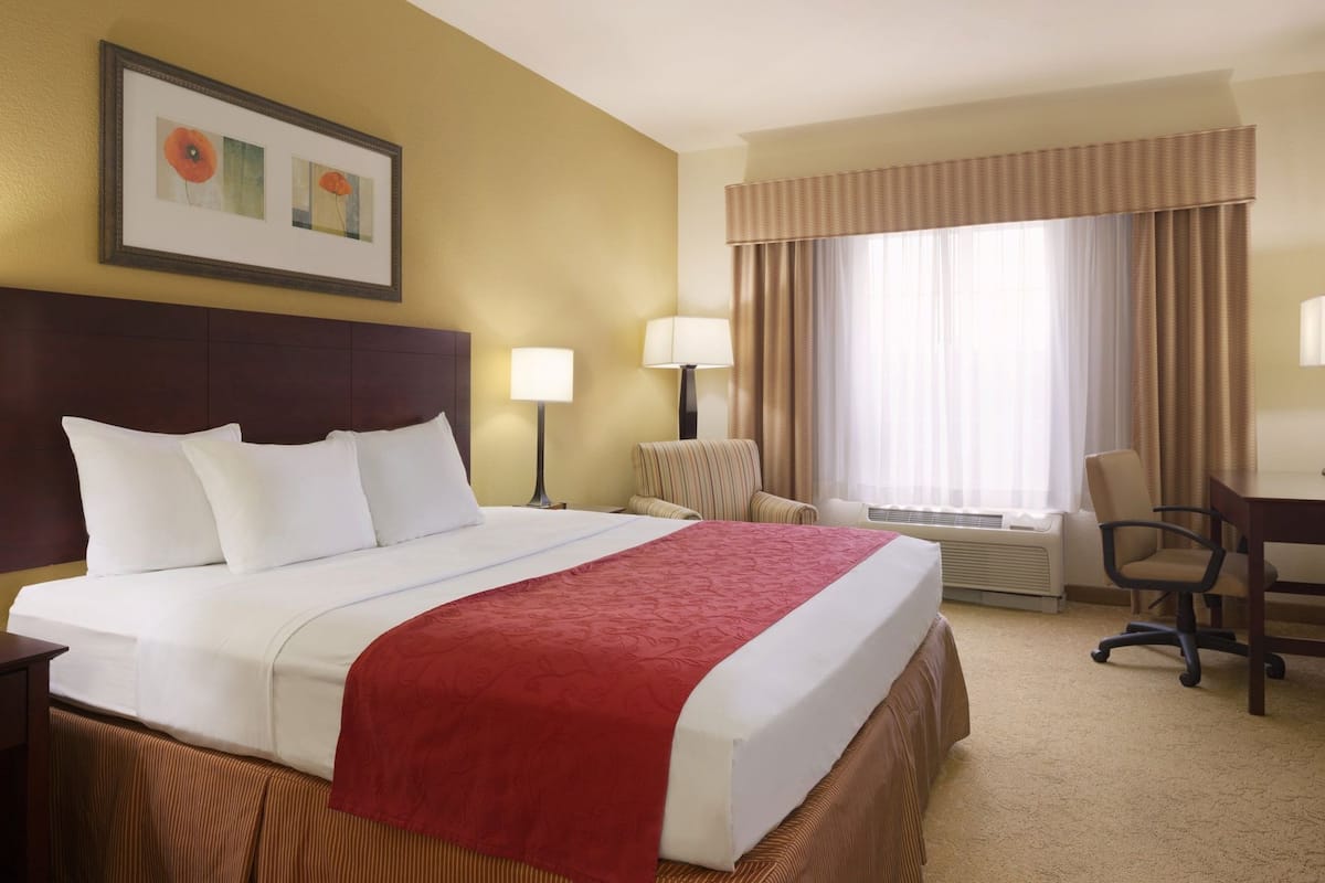 Premium bedding, desk, laptop workspace, blackout drapes