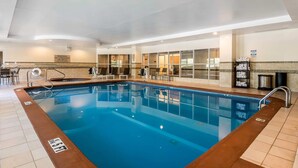 An indoor swimming pool with clear water, a lifeguard chair, and a sign indicating no lifeguard on duty. - Comfort Inn & Suites near Six Flags (Lithia Springs)