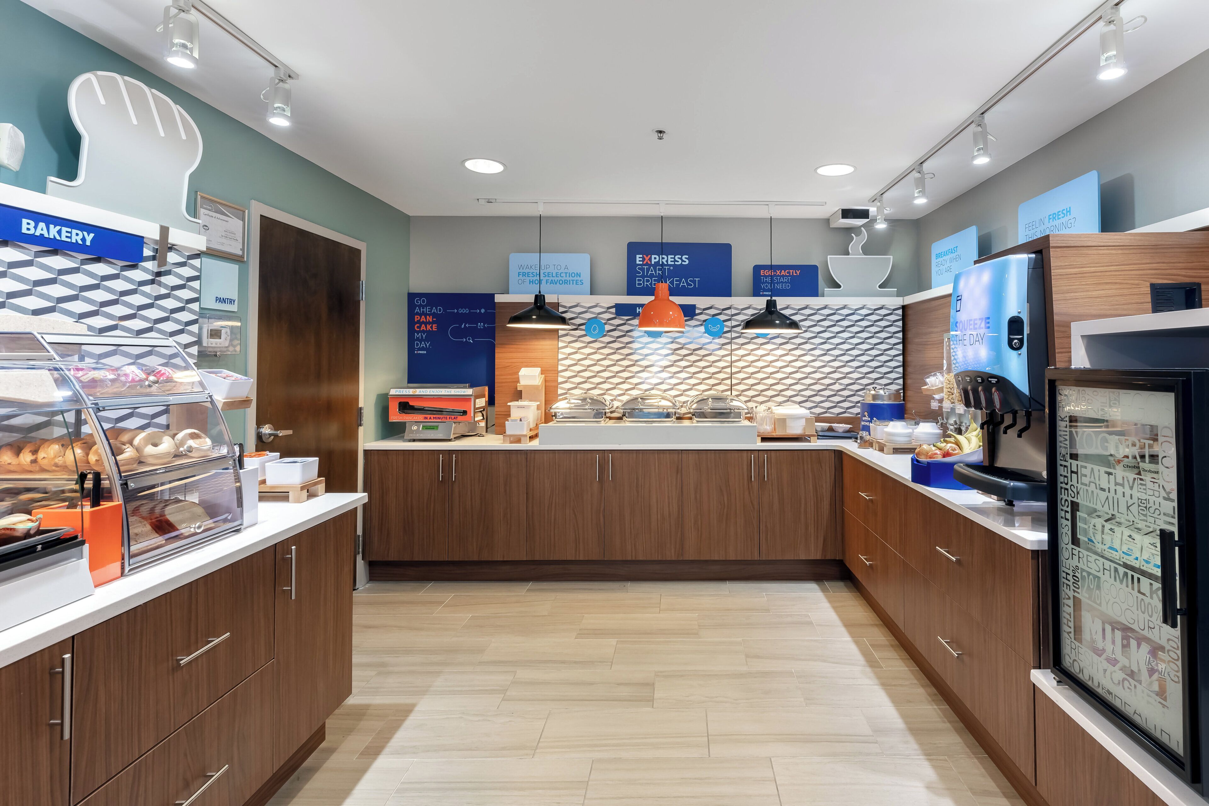 A modern breakfast area with a bakery section, a panini press, and a coffee machine.