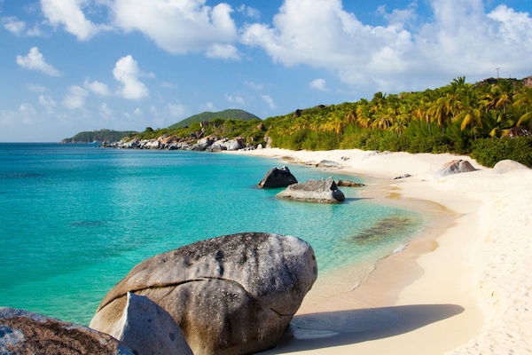 On the beach, white sand, sun loungers, beach umbrellas