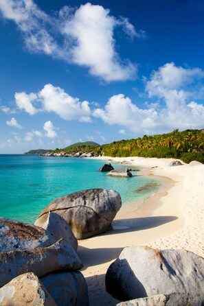 On the beach, white sand, sun loungers, beach umbrellas