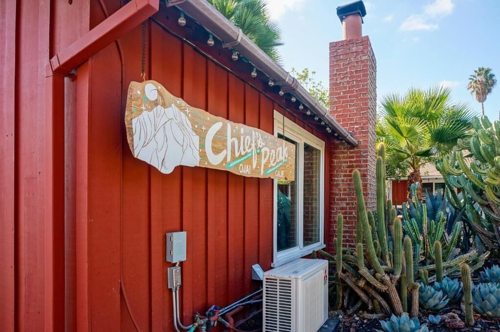 A red building with a sign that reads "Chief's Peak" and a window.