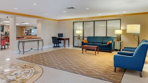 A hotel lobby with a seating area, a reception desk, and a bar. - Comfort Inn Anderson South (Anderson)
