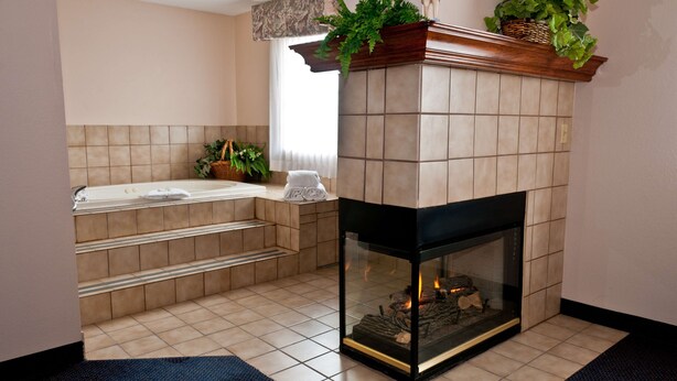 A modern bathroom with a bathtub, a shower, and a toilet. - Best Western Plus Brandywine Inn & Suites (Monticello)