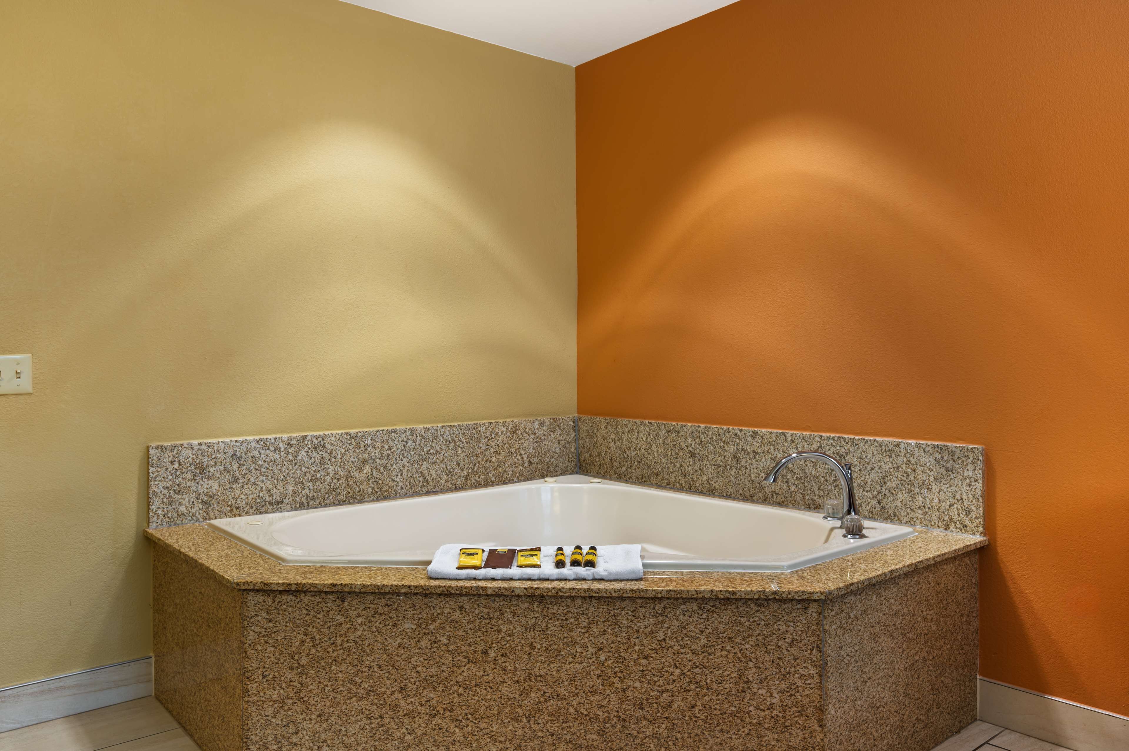 suite, 1 king bed, non smoking, jetted tub | desk, blackout curtains, iron/ironing board, cots/infant beds