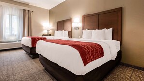 A hotel room with two beds, a large window with curtains, a wall-mounted lamp, and a carpeted floor. - Comfort Inn & Suites Streetsboro - Kent (Streetsboro)