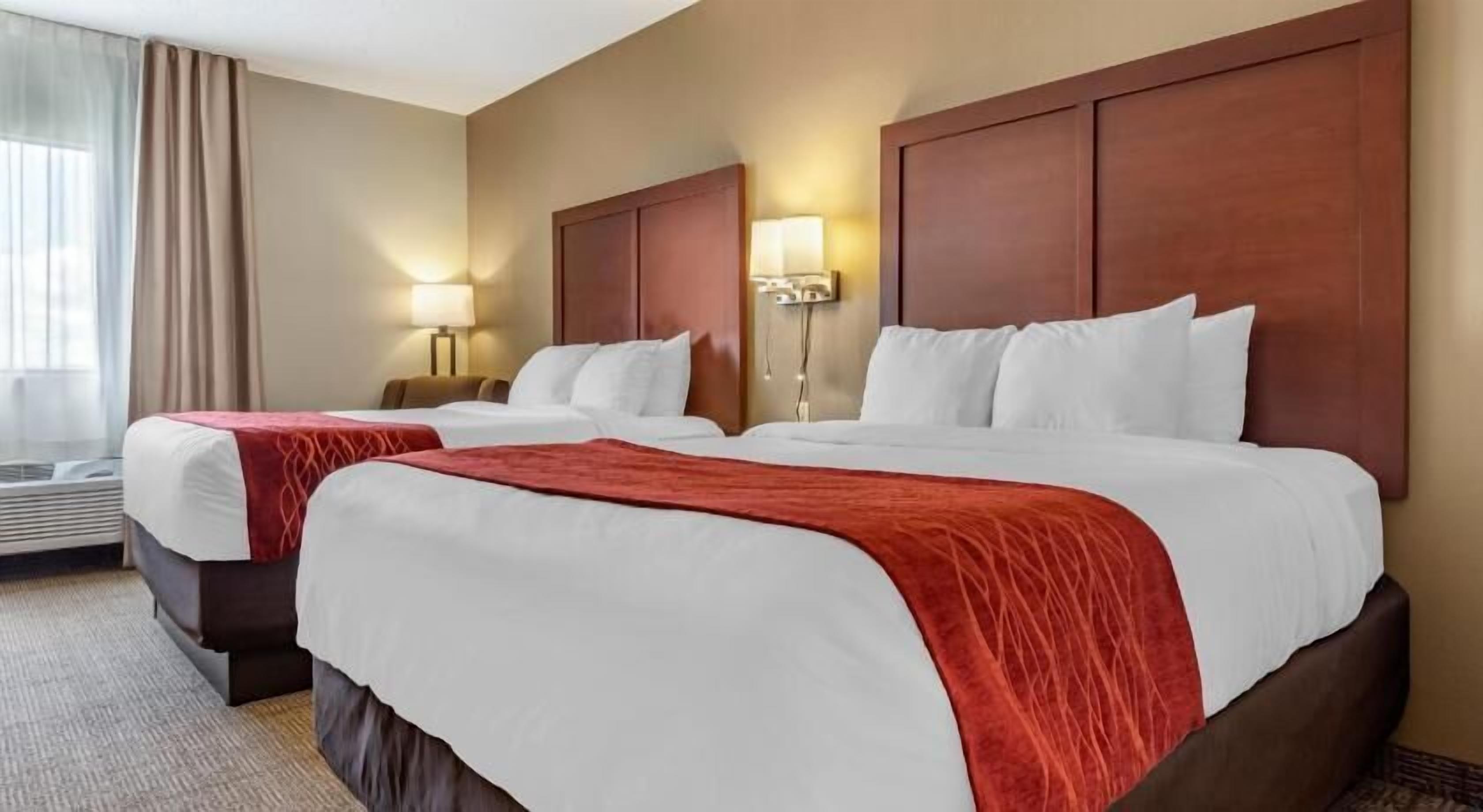 Premium bedding, desk, laptop workspace, blackout drapes