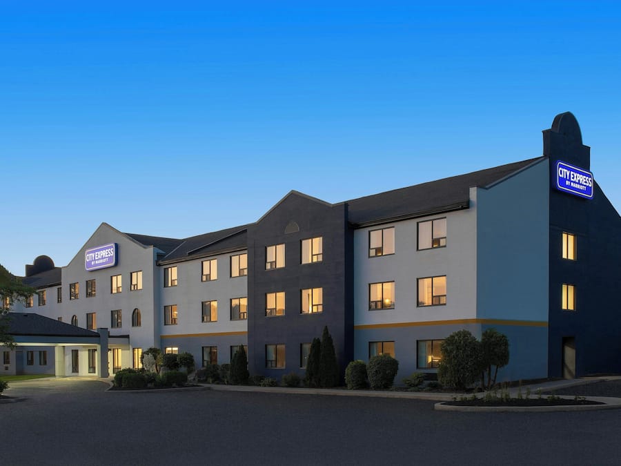 A multi-story hotel with a flat roof and a sign indicating it is a City Express by Marriott.