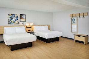 A hotel room with two beds, bedside tables, lamps, and artwork on the walls. - City Express by Marriott Port Hope Cobourg (Port Hope)