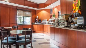 A modern restaurant with a central island, seating area, and a coffee machine.