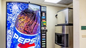 A vending machine with a Pepsi advertisement and a refrigerator. - Quality Inn Burkeville Hwy 360 & 460 (Burkeville)