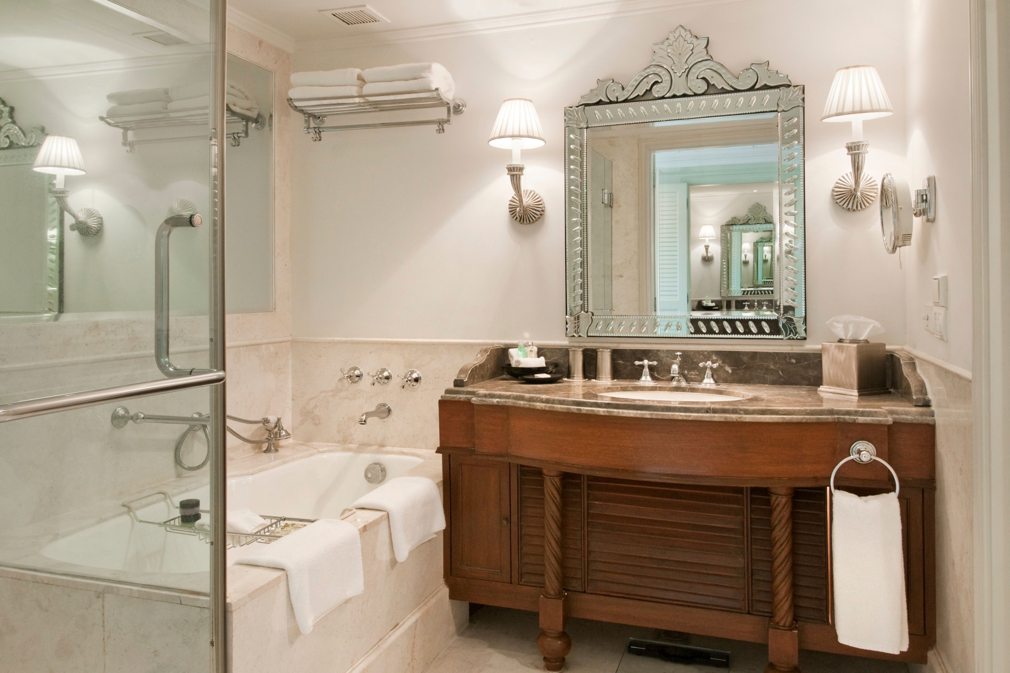 Un baño con bañera, tocador con espejo y cabina de ducha.