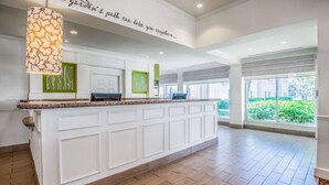 A spacious kitchen with a large island, white cabinetry, and a pendant light. - Hilton Garden Inn Wichita (Wichita)