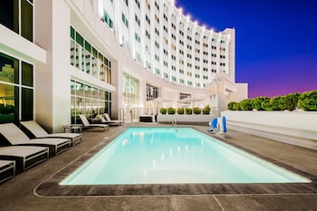 Outdoor pool, open 7:00 AM to 10:00 PM, sun loungers at The Commerce Casino & Hotel
