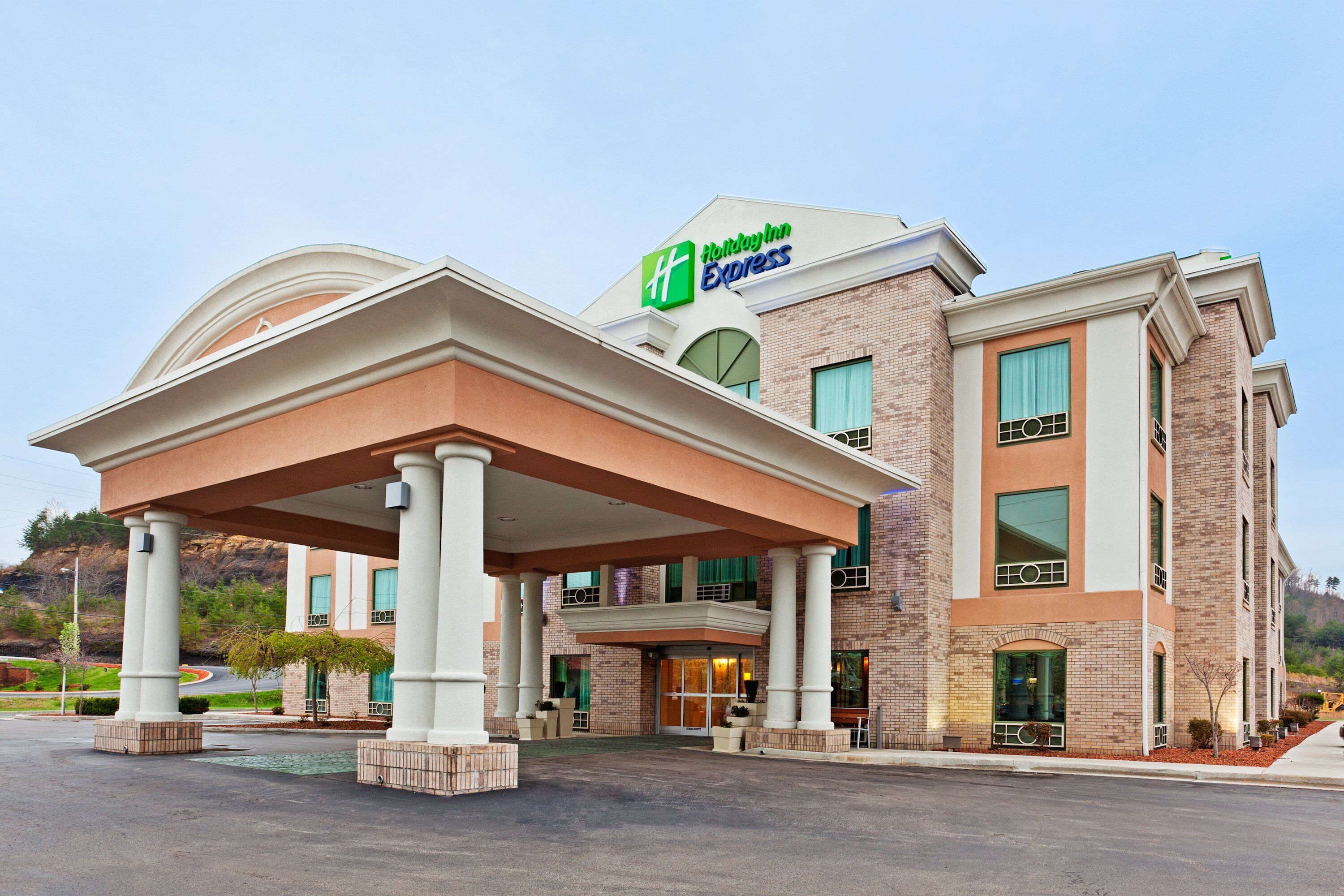 A Holiday Inn Express hotel with a covered entrance, brick facade, and multiple windows.