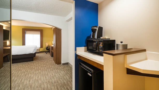 A hotel room with a bed, a desk, a microwave, and a coffee maker. - Holiday Inn Express Hotel & Suites Louisville East by IHG (Louisville)