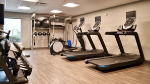 A gym with treadmills, dumbbells, and exercise balls. - Hampton Inn Medina (Medina)