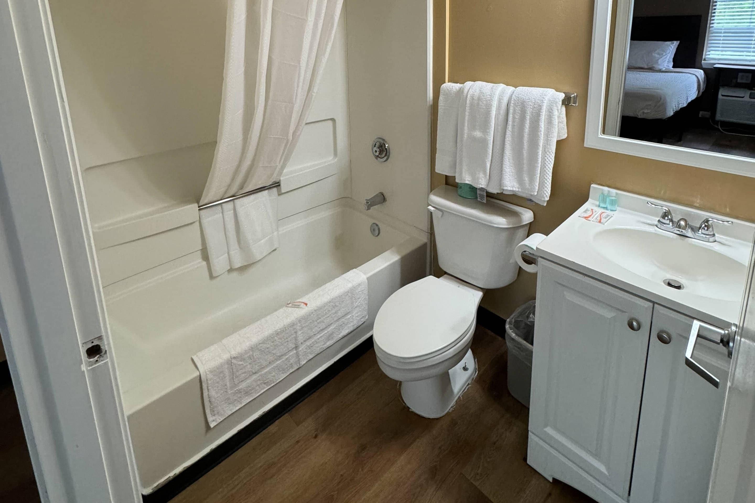 Un baño con bañera, inodoro y lavabo.