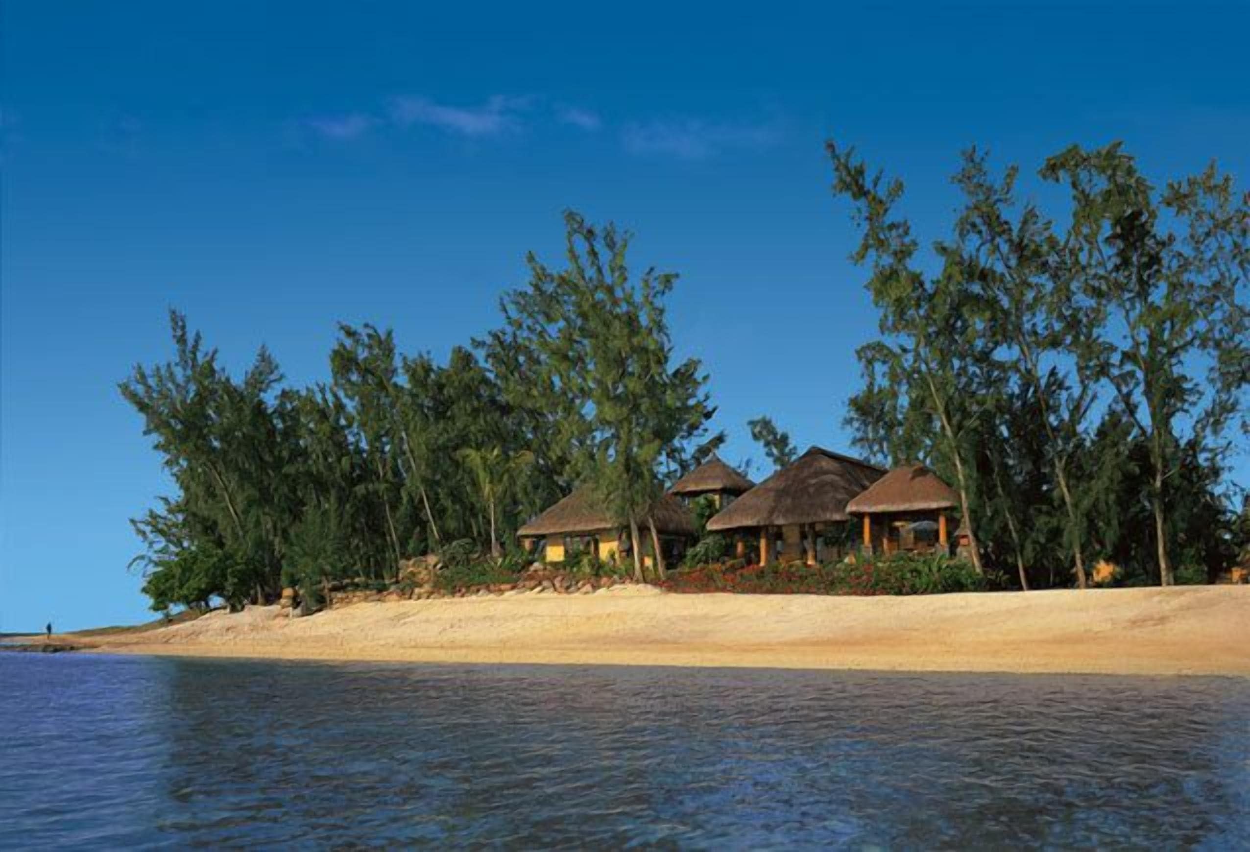 On the beach, white sand, sun loungers, beach umbrellas