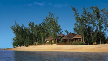 On the beach, white sand, sun loungers, beach umbrellas