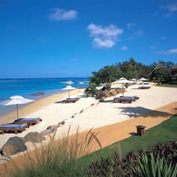 On the beach, white sand, sun loungers, beach umbrellas