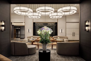 Hotel amenities such as safe, desk and work area at The Muse New York