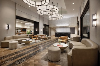 Hotel amenities such as safe, desk and work area at The Muse New York