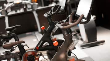 A stationary bike with a digital display and a handlebar.