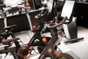 A stationary bike with a digital display and a handlebar.