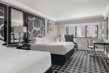 Hotel amenities such as safe, desk and work area at The Muse New York