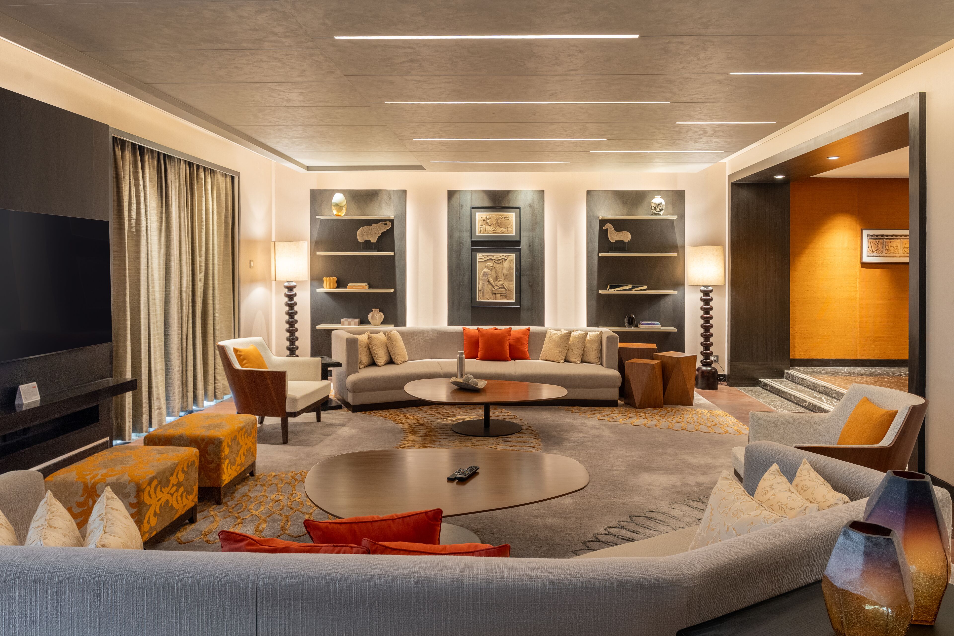 A modern living room with a sofa, coffee table, and TV.