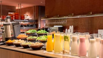 A buffet with various food items and beverages.