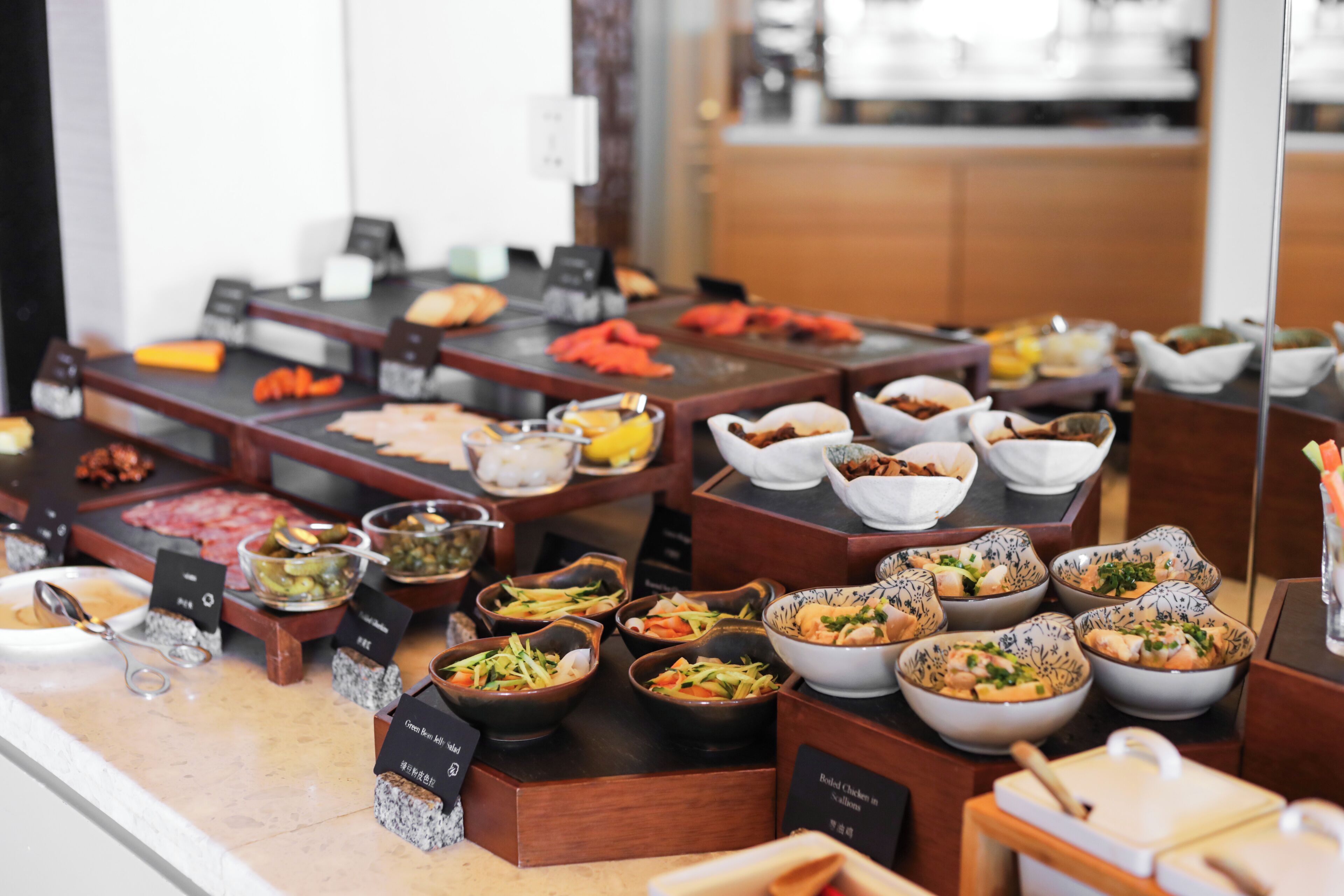 A buffet with various dishes and condiments.