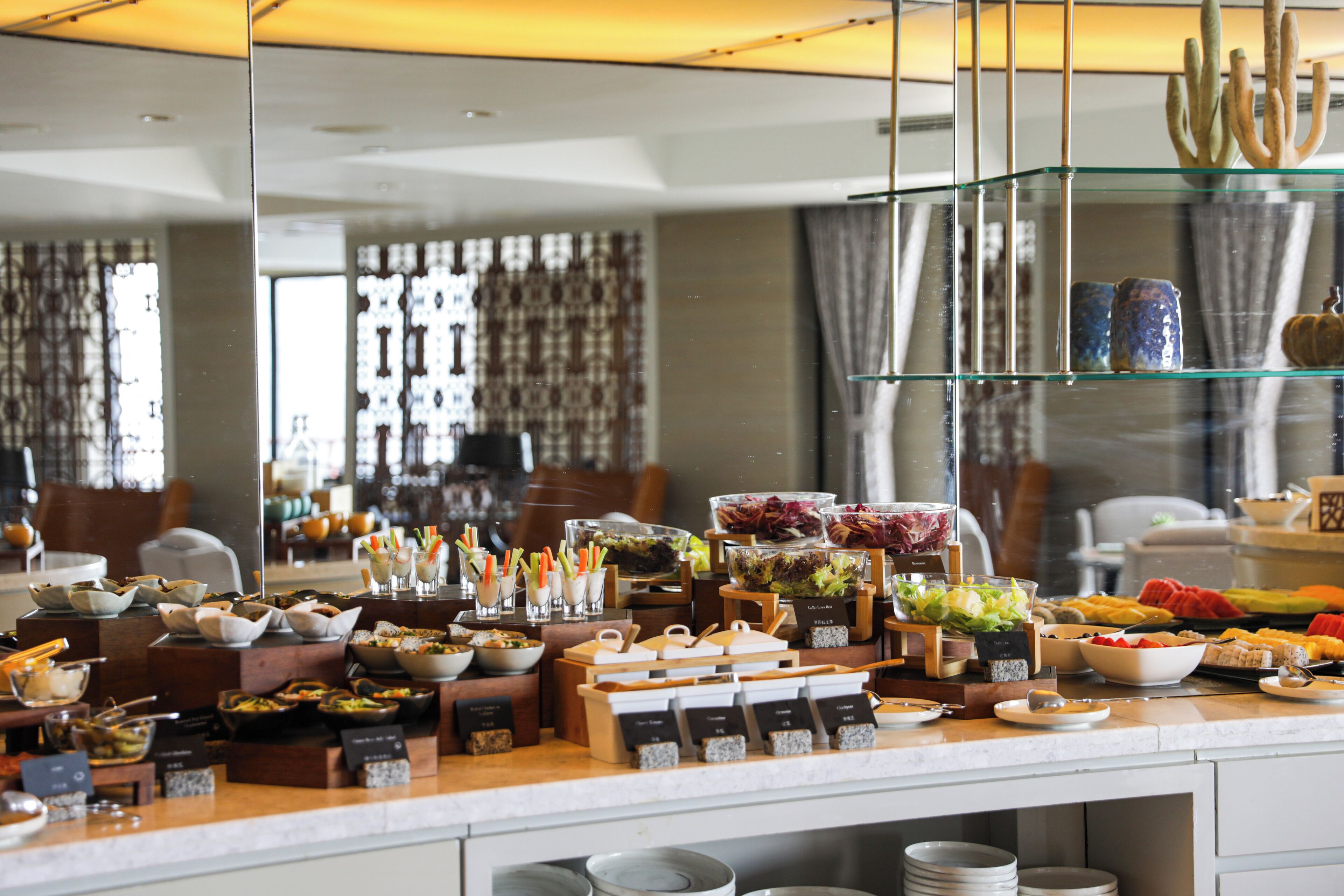 A buffet setup with various food items and containers.