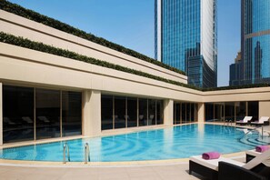 A modern hotel pool with clear blue water, surrounded by large windows and lounge chairs. - The Portman Ritz-Carlton, Shanghai (Shanghai)
