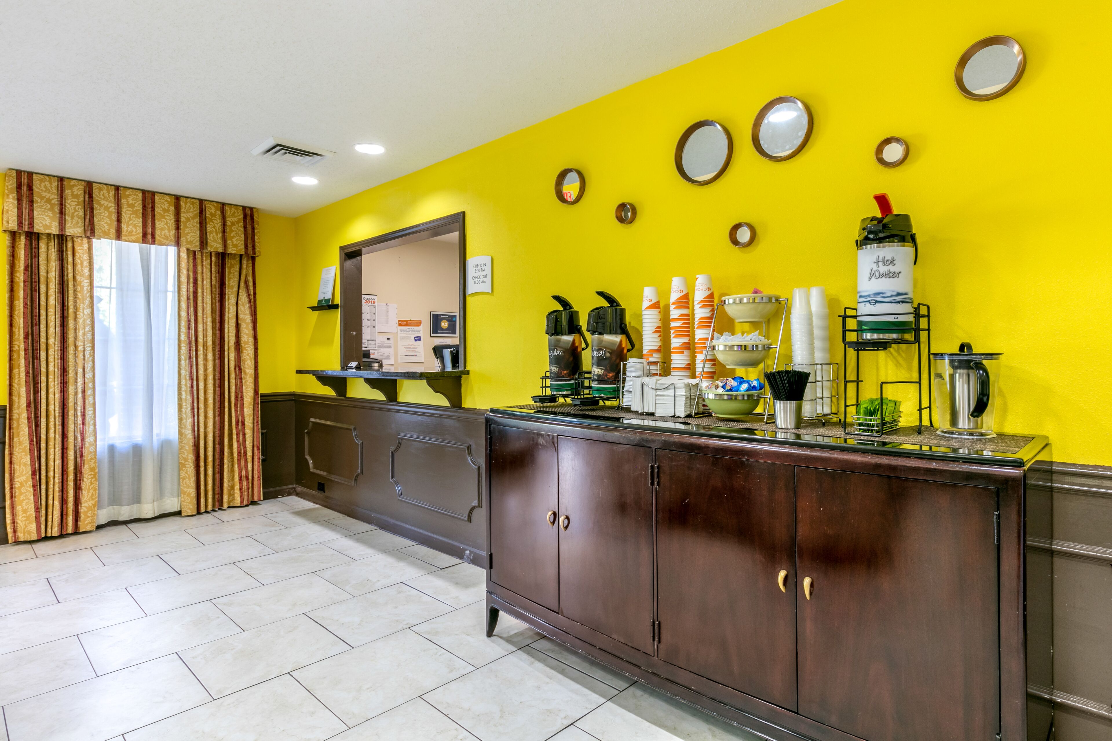 A reception area with a counter, a coffee machine, and a water dispenser.