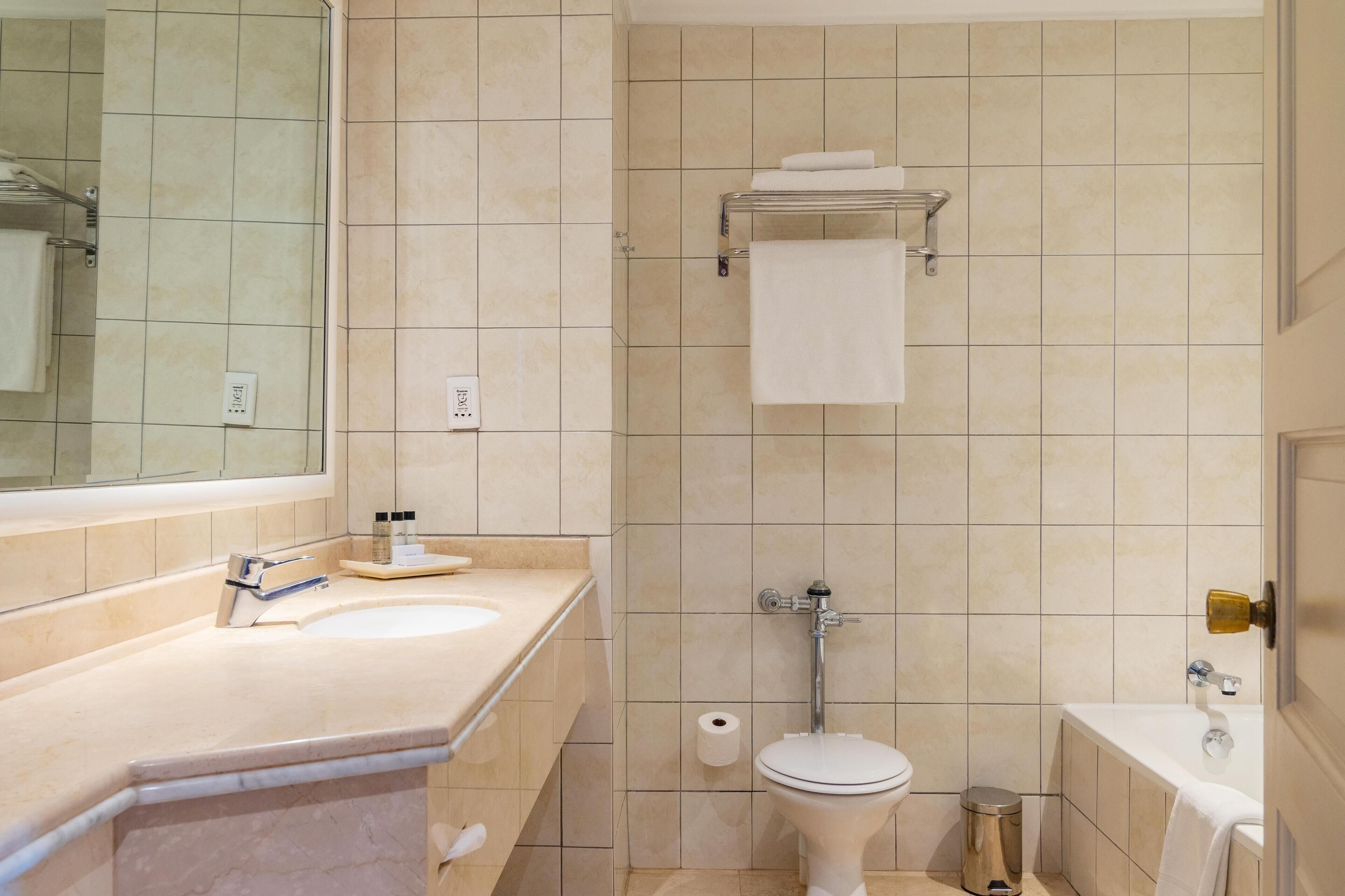 A bathroom with a sink, toilet, and bathtub.
