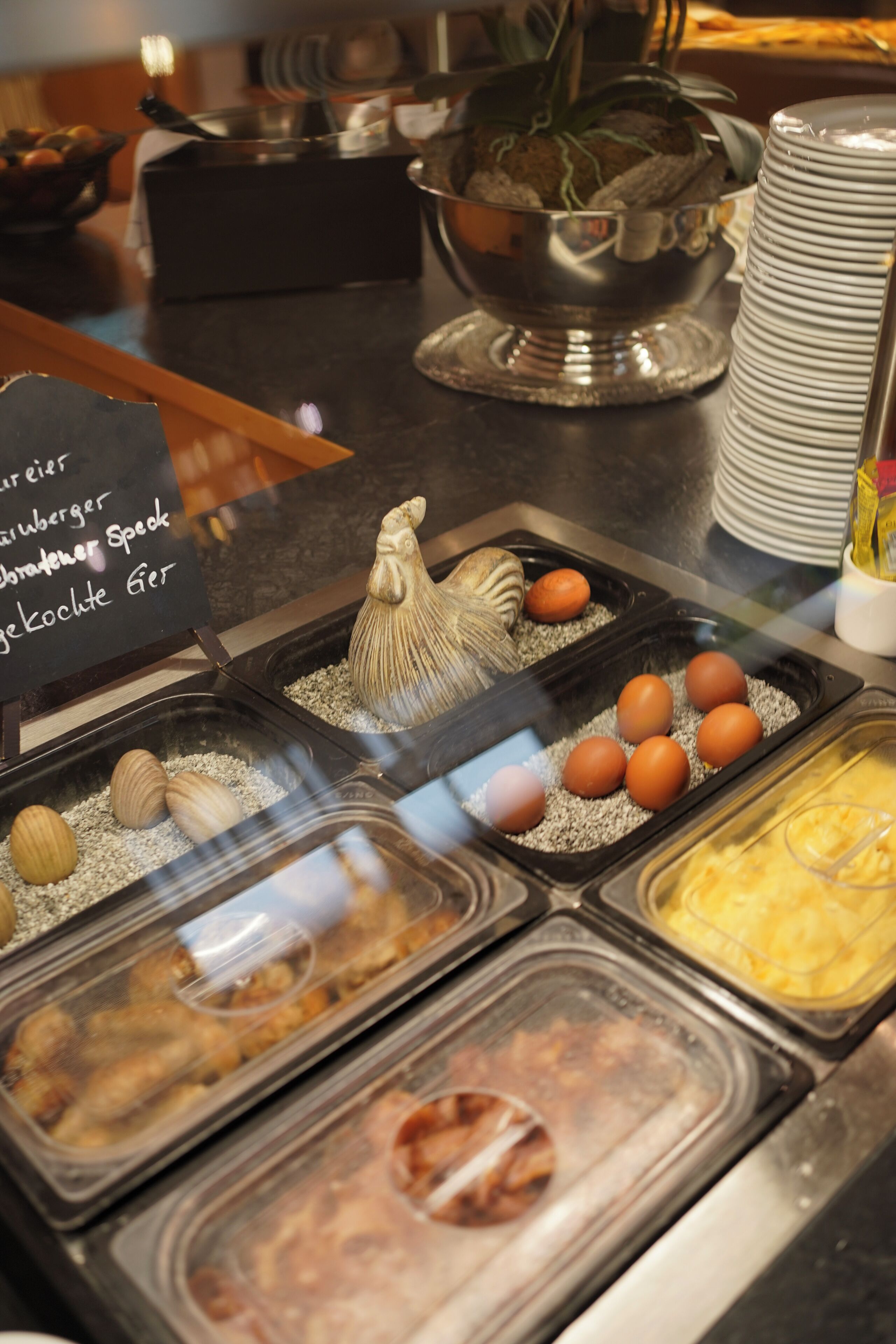 A buffet with various food items, including eggs and meat.