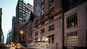 A historic building with a classic facade, large windows, and a prominent entrance.