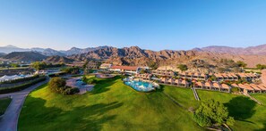 A resort with multiple buildings, a swimming pool, and a mountainous backdrop. - JA Hatta Fort Hotel (Hatta)