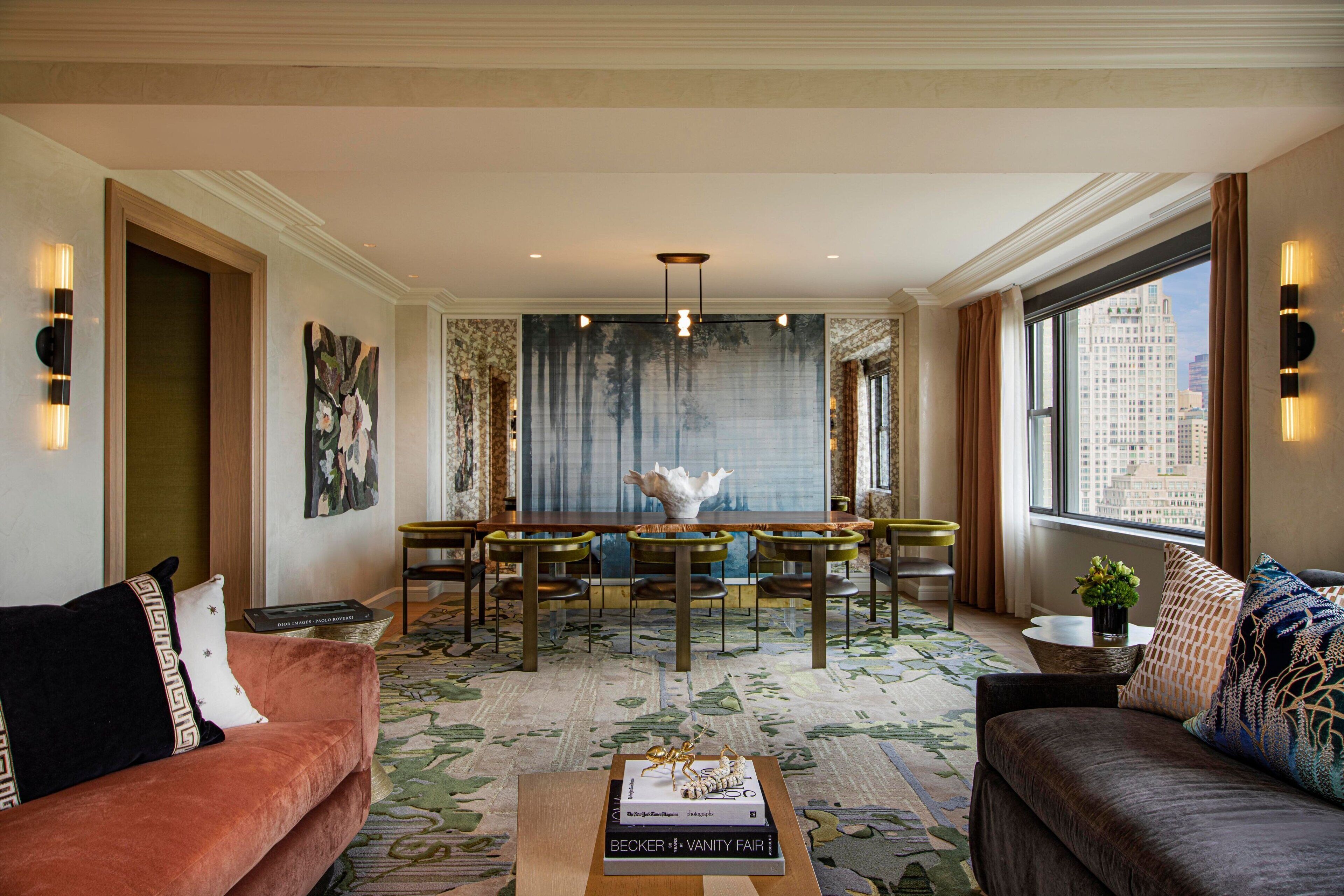 A spacious living area with a dining table, two sofas, and a coffee table.